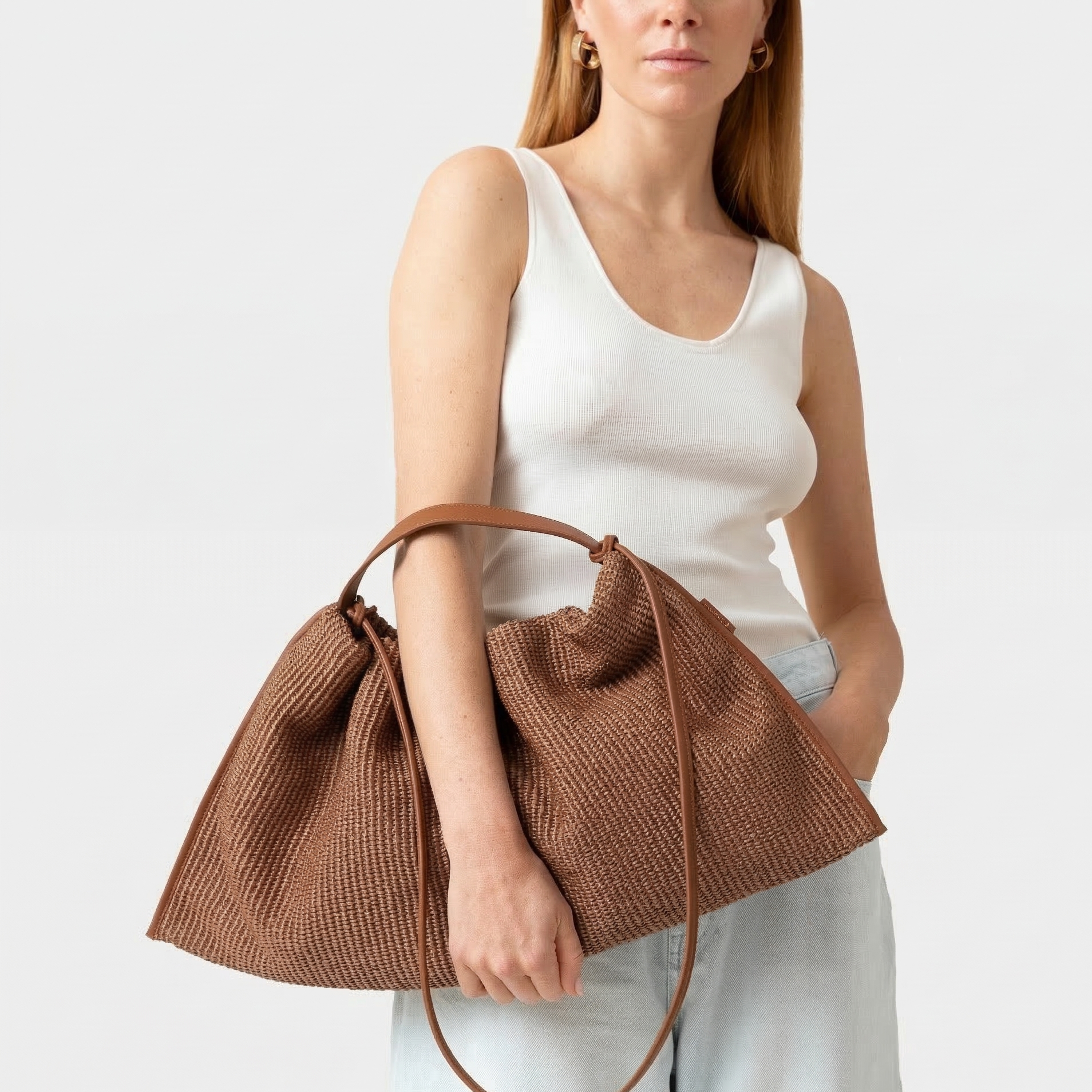 borsa destrutturata morbida in rafia e pelle marrone con manico e tracolla comoda brand Arron Made in Italy indossata