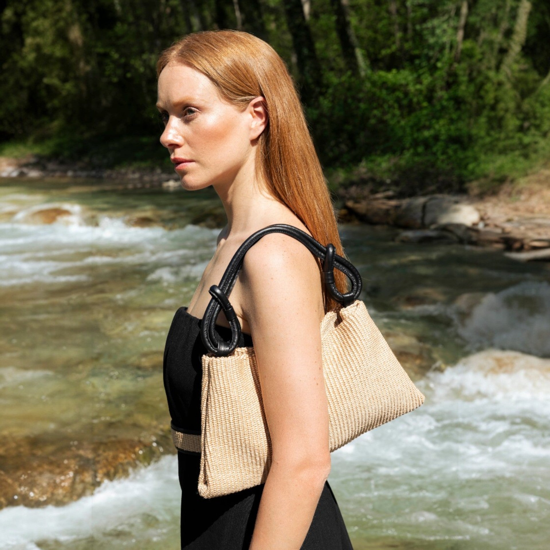 borsa hoppy hobo piccola del marchio Arron in rafia e pelle nera con manico con nodi decorativi leggera indossata a spalla
